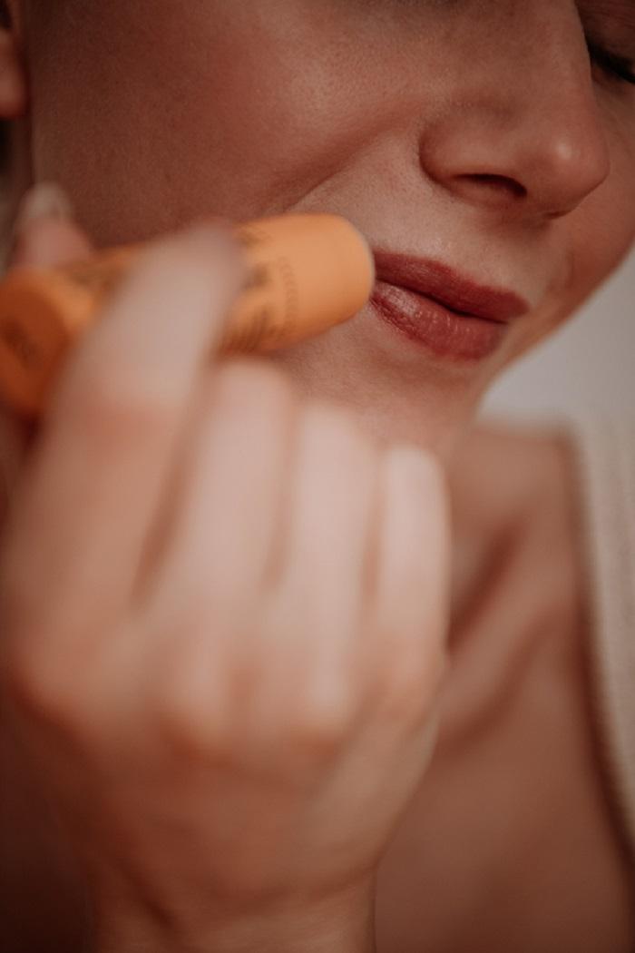 Applying-lip-balm-on-lips--by-Anastasija-Thirsty-for-tan